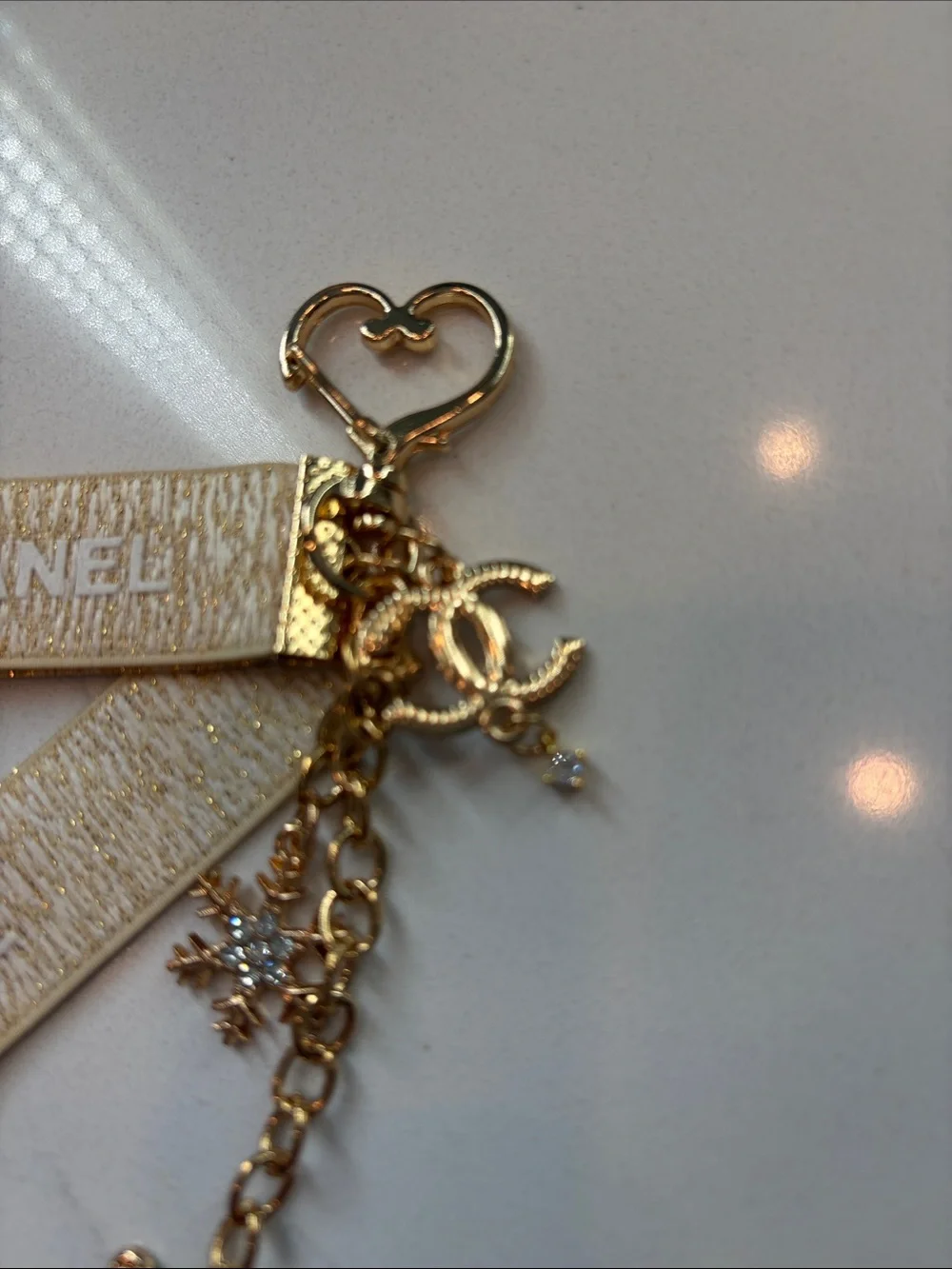 Beige and Gold Logo Strap Keychain with Charms